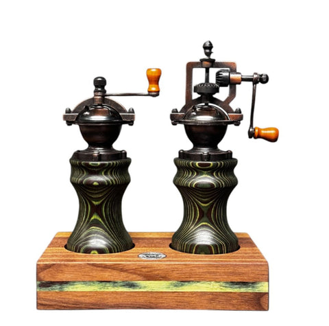 Das Camo Maser Bundle Pfeffermühle & Salzmühle von Jungo Design besteht aus Mühlen im Vintage-Stil mit Holzgriffen auf einem Holzsockel und weist ein ausgeprägtes und kompliziertes Design für einen antiken Look auf.