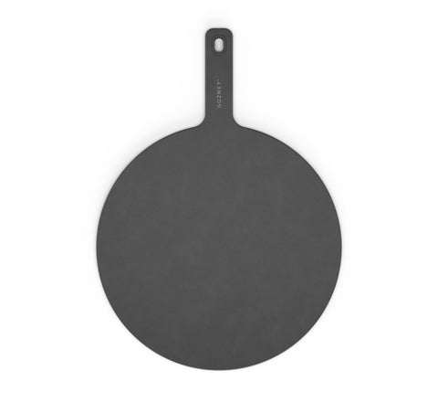 Der Gozney Pizza Servierteller (45 cm) ist ein runder, dunkelgrauer Pizzaschieber aus strapazierfähigem Fasermaterial. Er hat einen Griff mit dem eingravierten Wort „Gozney“ und ein Loch zum Aufhängen. Der Hintergrund ist schlicht weiß.