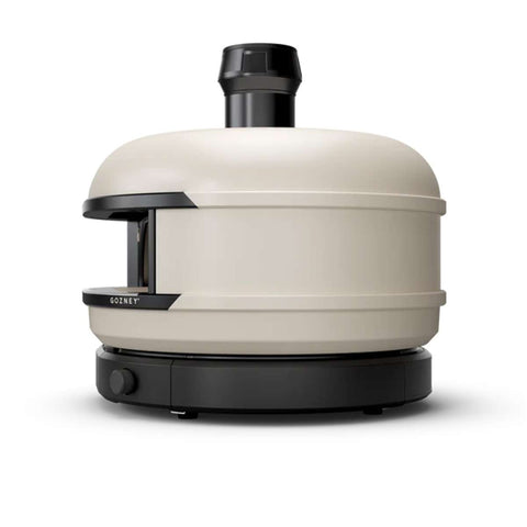 Der Gozney Dome S1 Gas-Pizzaofen ist ein beige-schwarzer, kuppelförmiger Gas-Pizzaofen, der sich perfekt für die Zubereitung von Restaurantqualität zuhause eignet. Mit einem Kamin an der Oberseite und einer kleinen Öffnung zum Einlegen der Pizza besticht er durch sein elegantes Design und verfügt über eine Temperaturregelung an der Unterseite.