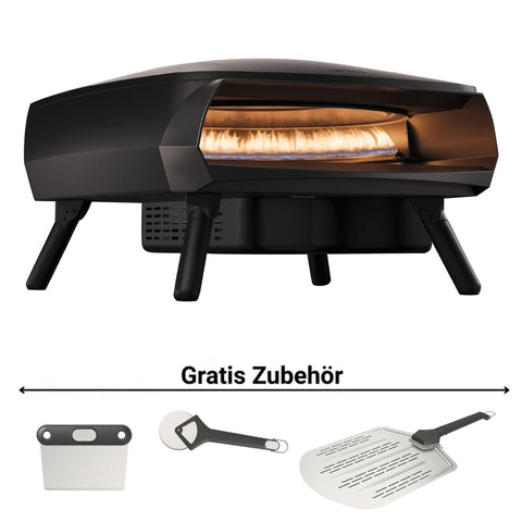 Der Witt ETNA ROTANTE Gas Pizzaofen mit rotierendem Stein von Witt steht auf vier Beinen. Drei Gratis-Zubehörteile - Pizzaschneider, -schaufel und Teigschneider - liegen davor. Perfekt für knusprige Pizzen bei 500°C.