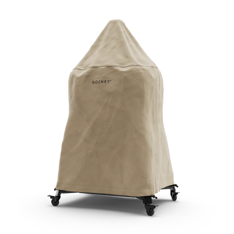 Die beige Gozney Abdeckhaube für Dome 2.0 / Dome 2.0 XL Lang schützt den Outdoor-Ofen zuverlässig vor Wind und Wetter; wetterfest, mit Gozney-Logo, stilvoll präsentiert vor weißem Hintergrund.