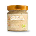 Ein Glastiegel der „Bio Mandelcreme Convivia“ von Convivia mit goldenem Deckel, Mandelbildern und der Aufschrift „Vegan“ unterstreicht die biologischen Qualitäten der Creme.