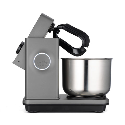 Die Wilfa Probaker NXT Küchen- und Knetmaschine in Grau verfügt über eine 7-Liter-Edelstahlschüssel, einen schwarzen Rührarm, eine beleuchtete „wilfa“-Taste und ein Dual-Action-Knet-System für optimale Ergebnisse. Abgebildet in Seitenansicht vor weißem Hintergrund.